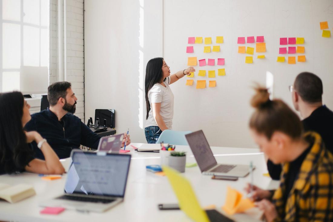 Consultants mapping ideas on sticky notes